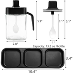 A set of three glass and wooden spice jars, with lids and spoons.